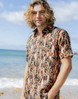 Men's short sleeve shirt featuring a Grass Tree design in black with burnt orange and sage green accent