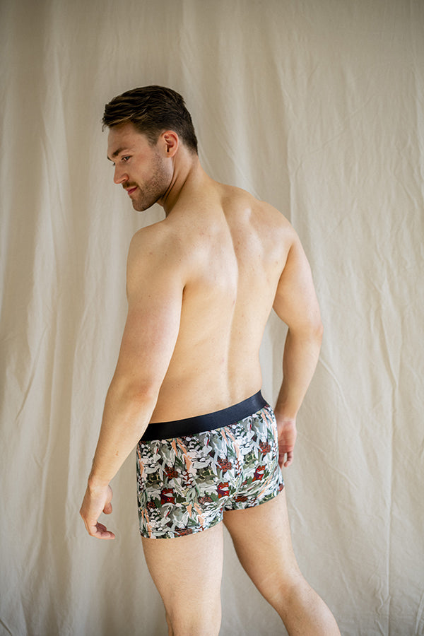 Eco-friendly boxer briefs featuring a leafy Spotted Gum pattern on a green base