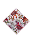 Botanical-themed pocket square with vibrant prints of native flowers in pink, red, green, white, and orange, offering a statement piece for any upscale occasion