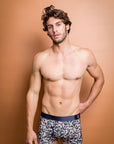 Eco-friendly boxer briefs adorned with delicate Flowering Gum floral prints and dark green leaves
