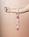 Stylish botanical tie crafted from cotton, featuring vivid prints of red Waratah, pink Desert Pea, and orange Wax Flowers, perfect for special occasions