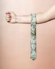 Chic cotton tie in sage with a detailed fan palm leaf pattern, perfect for adding a touch of the tropics to formal wear