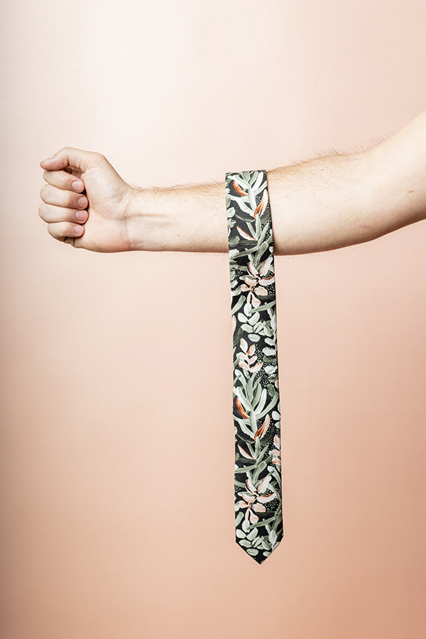 Green cotton tie featuring a detailed protea floral print, highlighting the intricate beauty of this flower