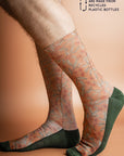 Eco-friendly socks featuring a Flowering Gum design in terracotta with pink blossoms and green leaves, perfect for nature lovers