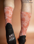Eco-friendly socks featuring a Kangaroo Paw print in burnt orange, inspired by the unique flora of Australia