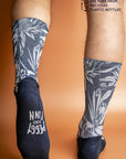 Eco-friendly socks featuring a vibrant print of Australian native plants in deep blue and white, perfect for the environmentally conscious