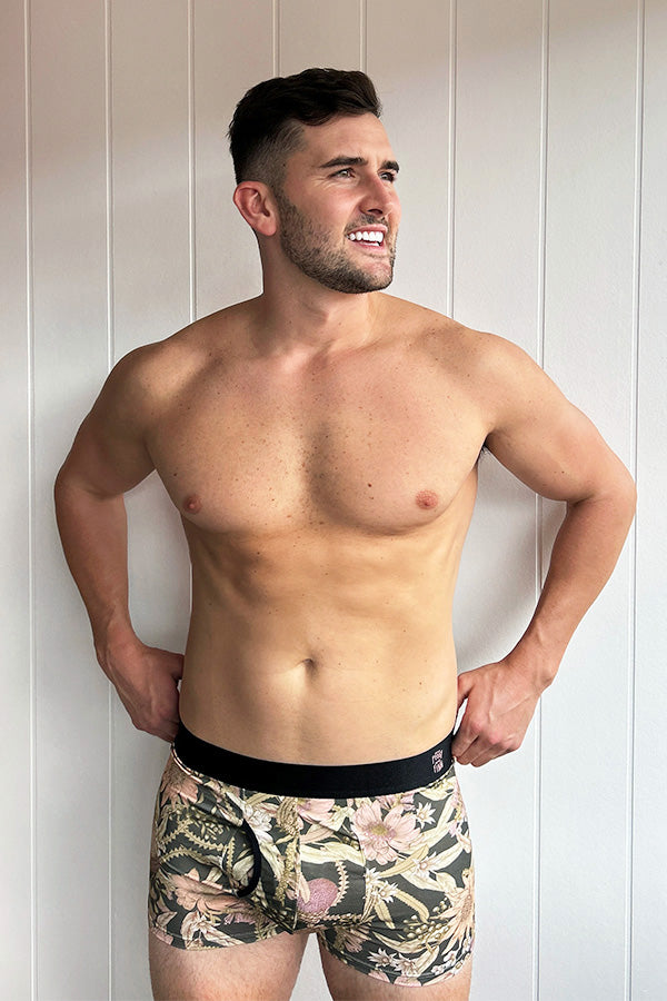 Men's bamboo underwear featuring a charcoal base with Banksia and Waratah prints in peach and pink tones