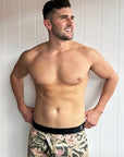 Men's bamboo underwear featuring a charcoal base with Banksia and Waratah prints in peach and pink tones