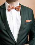 Modern and stylish bow tie featuring a detailed kangaroo paw print in burnt orange, inspired by Australian native flora with intricate yellow and green patterns for a vibrant look
