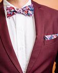 Modern and stylish bow tie featuring a detailed protea print in rich burgundy, complemented by shades of pink and green, inspired by the vibrant beauty of this flower