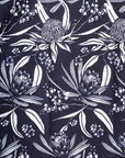 Intricate native Australian flora print featuring vibrant flowers and foliage, showcasing the beauty of local plant life in Navy and White colour way