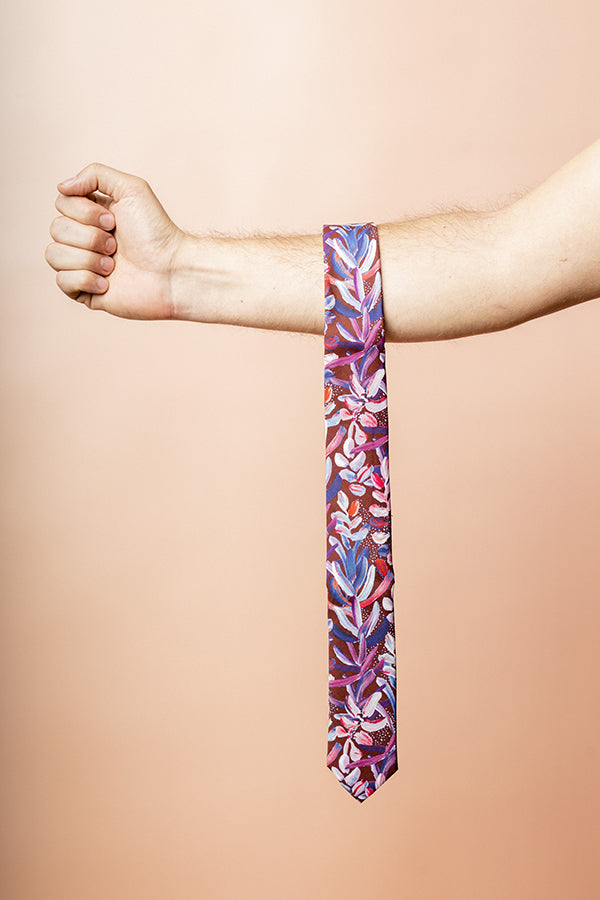 Elegant men's tie in burgundy with a sophisticated protea flower pattern, perfect for adding a touch of nature-inspired style
