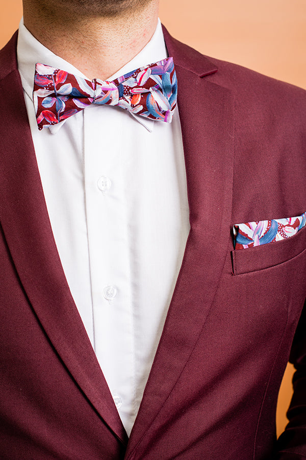 Stylish 100% cotton pocket square with a classic burgundy background and contrasting white protea flowers, designed to elevate any suit