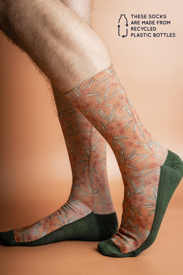 Eco-friendly socks featuring a Flowering Gum design in terracotta with pink blossoms and green leaves, perfect for nature lovers