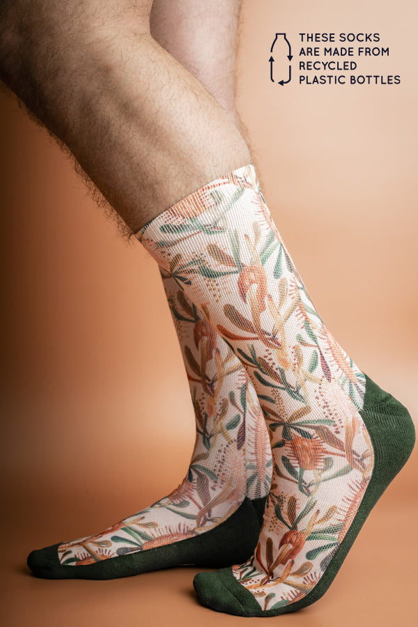 Sustainable socks made from recycled materials, adorned with muted tones of mocha, burnt orange, and sage green in a Grass Tree design